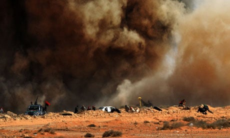Libyan rebel fighters run for cover as a