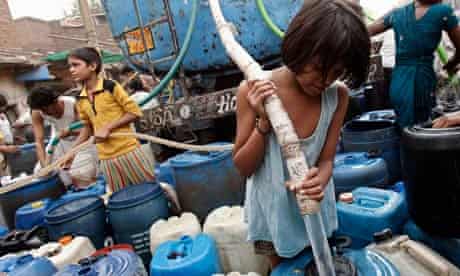 A girl fills up a container with drinking water in Delhi