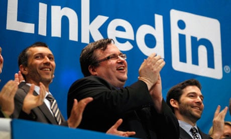 LinkedIn founder Reid Garrett Hoffman (centre) applauds as its shares start trading
