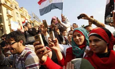 Egyptians use their mobile phone to record celebrations in Cairo's Tahrir Square