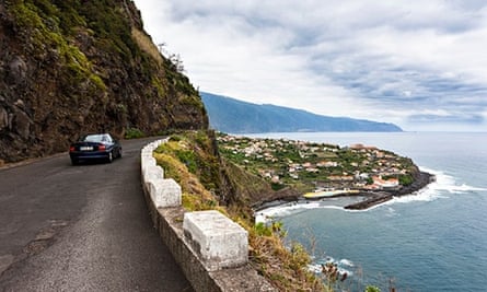 Car driving along coastal cliffs