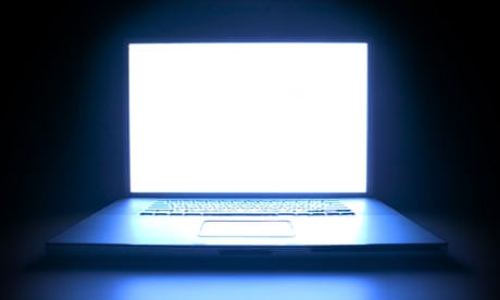 A laptop computer illuminated in the dark
