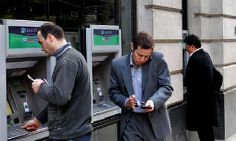 Customers use ATM machines