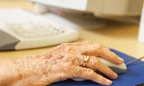 Older person's hand on a computer mouse