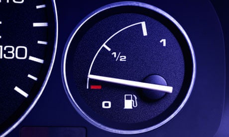 A car dashboard showing a speedo and fuel gauge