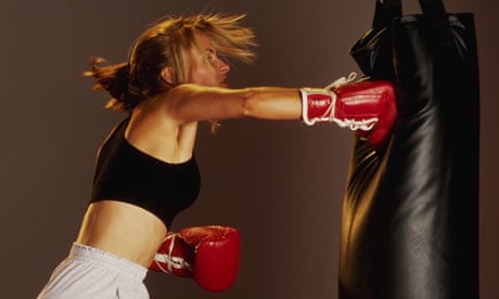 A woman punching a punch bag