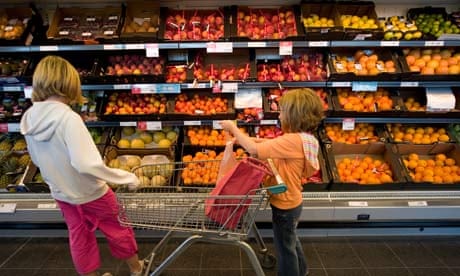 Two young girls shopping for fresh fruit and vegetables