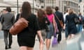 Men and women walking over London Bridge