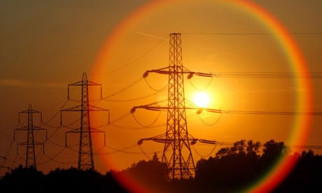 The sun sets behind pylons in central England