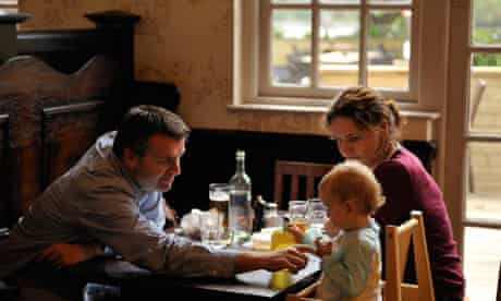 A young family dines at a pub in Fulham, London