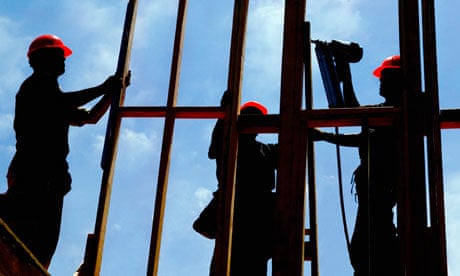 Construction workers with a window frame