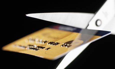 Scissors cutting up credit card
