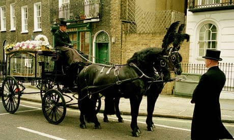 A horse drawn hearse at a funeral