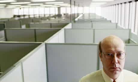 A man standing in an empty office