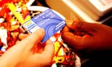A RBS Visa debit card being handed to a shop assistant