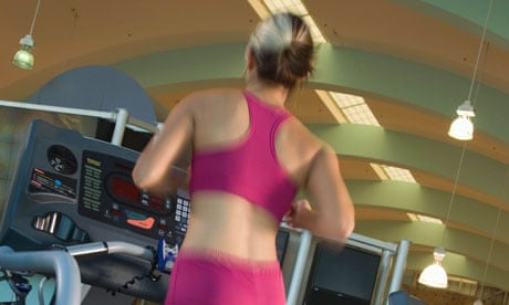 A woman Jogging on a gym treadmill
