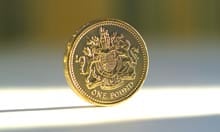 A £1 coin in a shaft of light