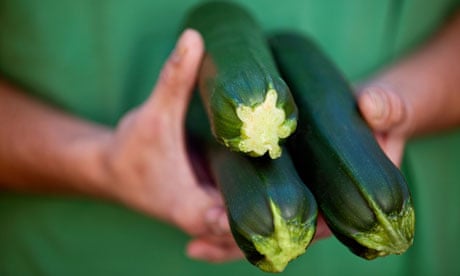 A man holding courgettes