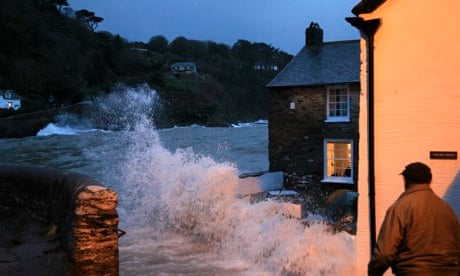 A holiday cottage takes the full force of a wave at Lee near Ilfracombe, North Devon