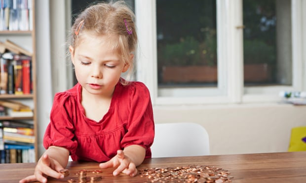 Girl playing with pennies at table