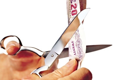 scissors cutting 20 pound note