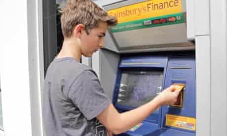 young boy uses debit card