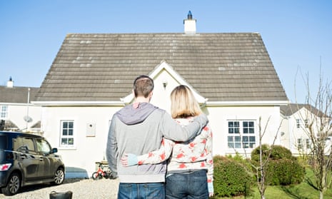 Couple in front of house