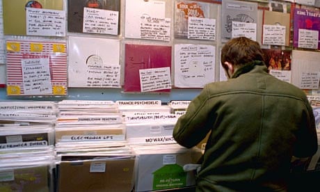 Man searches through racks of vinyl at a record shop