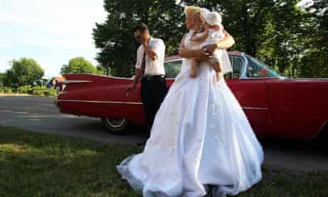 A bride with a kid and the groom, getting out of an american muscle car