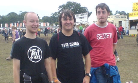 Festival goers show off their gig t-shirts