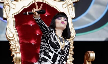 Jessie J at Glastonbury festival on a gold throne pursing her lips and looking hugely egotistical