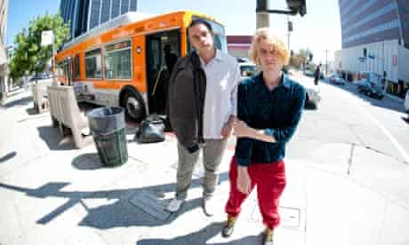 Girls members Christopher Owens and Chet 'JR' White in front of an LA city bus