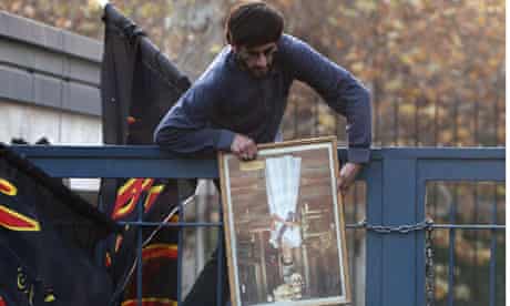 An Iranian protester storms the British embassy in Tehran