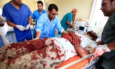 Libyan medics treat an injured rebel fighter