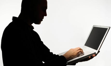 Silhouette of man using laptop