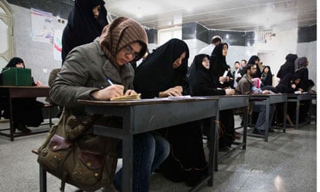 Women fill in their ballots during Iran's parliamentary election, at a mosque in southern Tehran