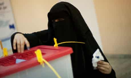 A woman in a veil votes in Tripoli