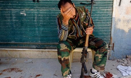 A Free Syrian Army fighter reacts after his friend was shot