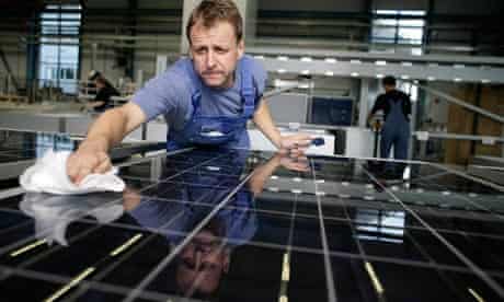 A worker cleans solar cells aat Solar World in Solar Valley, Freiburg