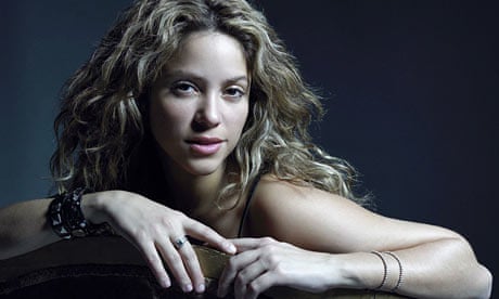 Shakira leaning over chair