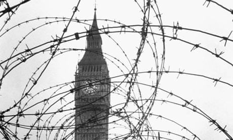 Big Ben partially obscured by barbed wire. 