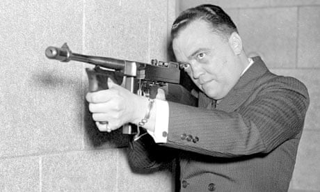 FBI director J Edgar Hoover aims machine gun