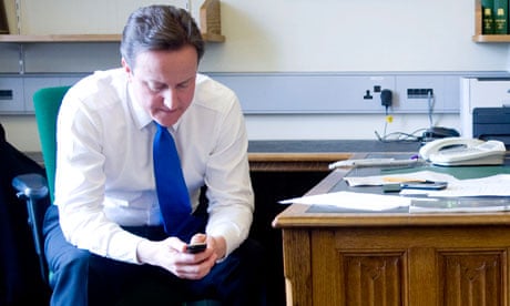 David Cameron writes text on mobile phone