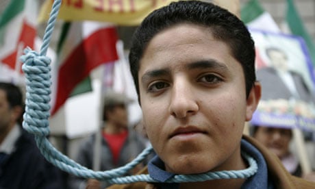 Members of the National Council of Resistance for Iran depict a public hanging
