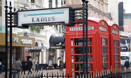 Ladies toilet sign and red phone box in London