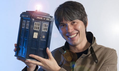 Professor Brian Cox holds a model of Doctor Who's Tardis