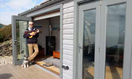 Stan Cullimore and his dog in the doorway of his luxury shed
