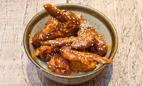 Bowlful of glistening Korean chicken wings at Flesh & Buns