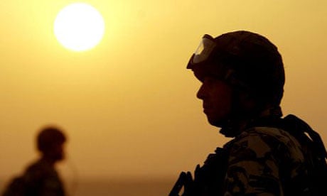 A British soldier stands guard in a location south of Basra, Iraq, in April 2003. Photograph: Dan Chung