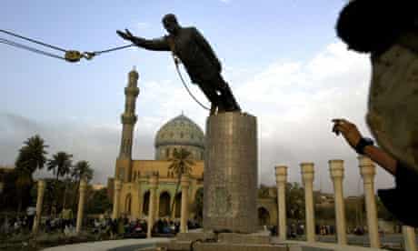 A US marine watches a statue of Saddam Hussein being toppled in Baghdad on April 9 2003. Photograph: Jerome Delay/AP